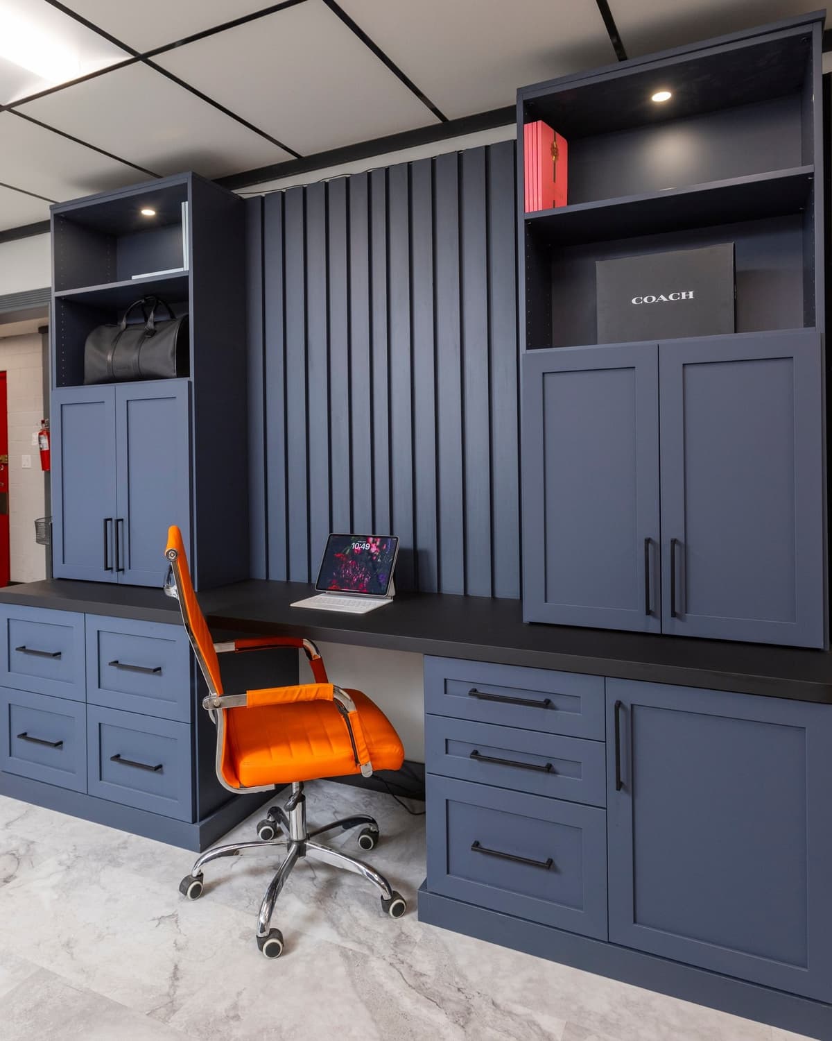 Custom navy blue home office with built-in desk and cabinets