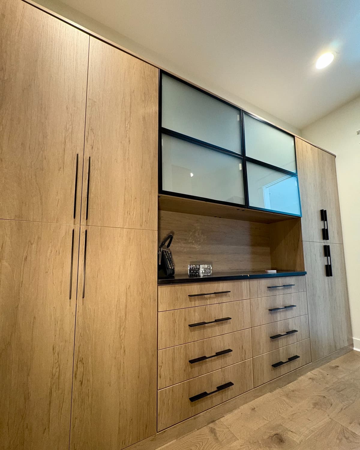 Modern office wardrobe with walnut finish and frosted glass panels
