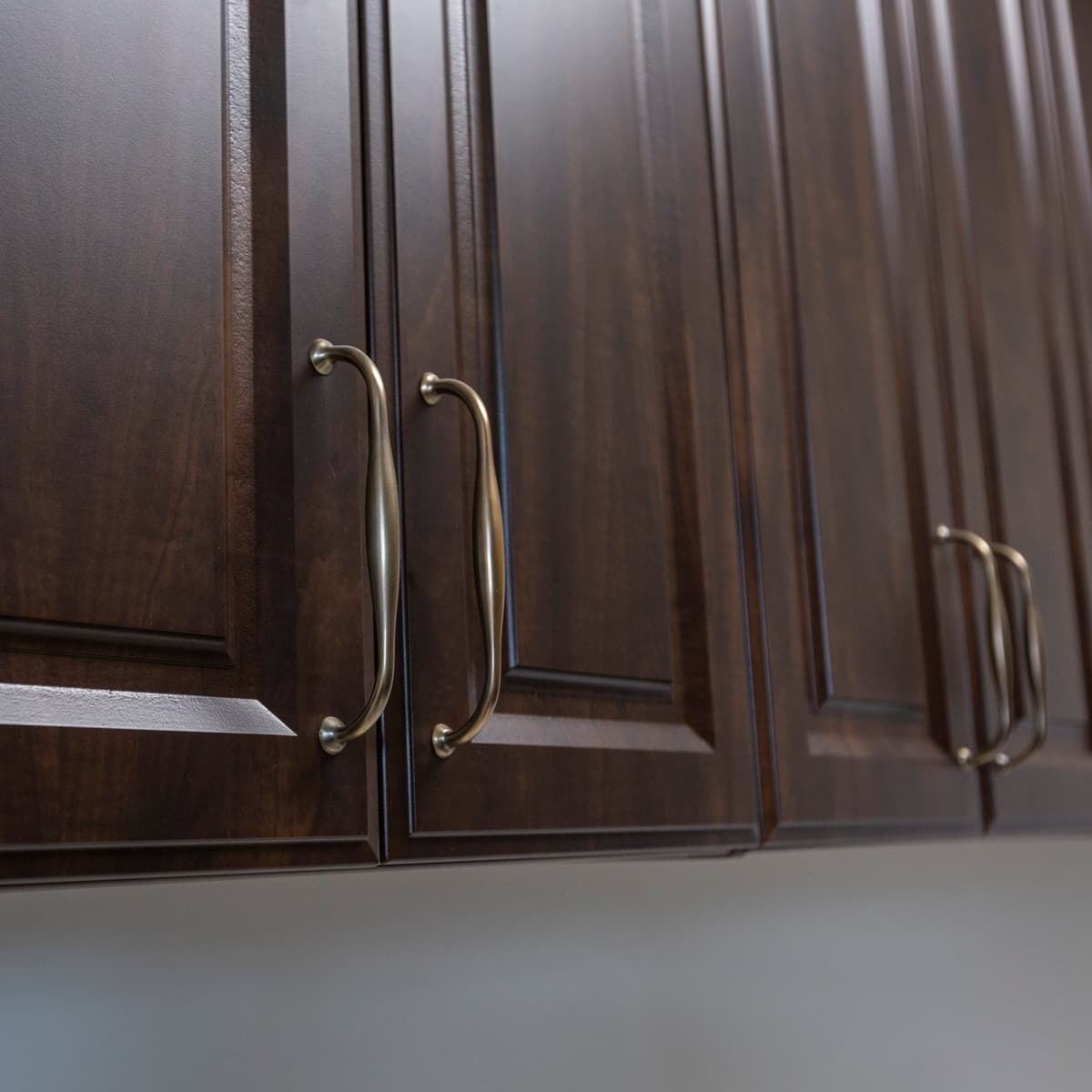 Dark wood cabinet detail with brass hardware