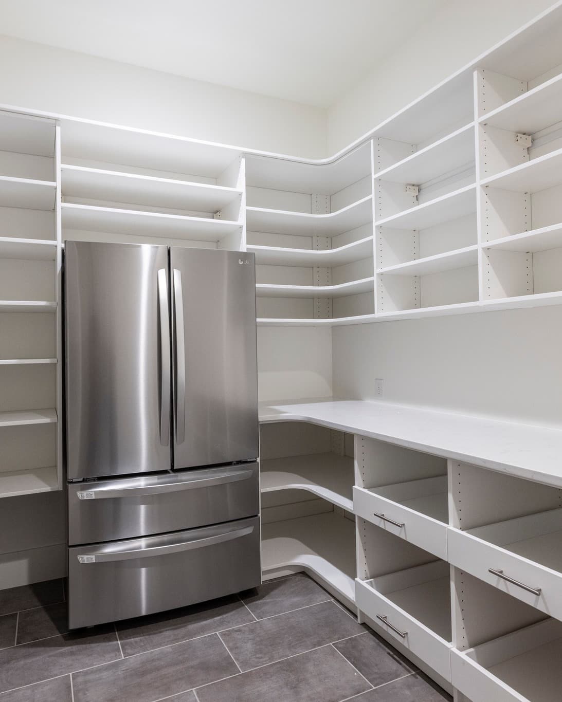 Organized walk-in pantry filled with storage containers and supplies