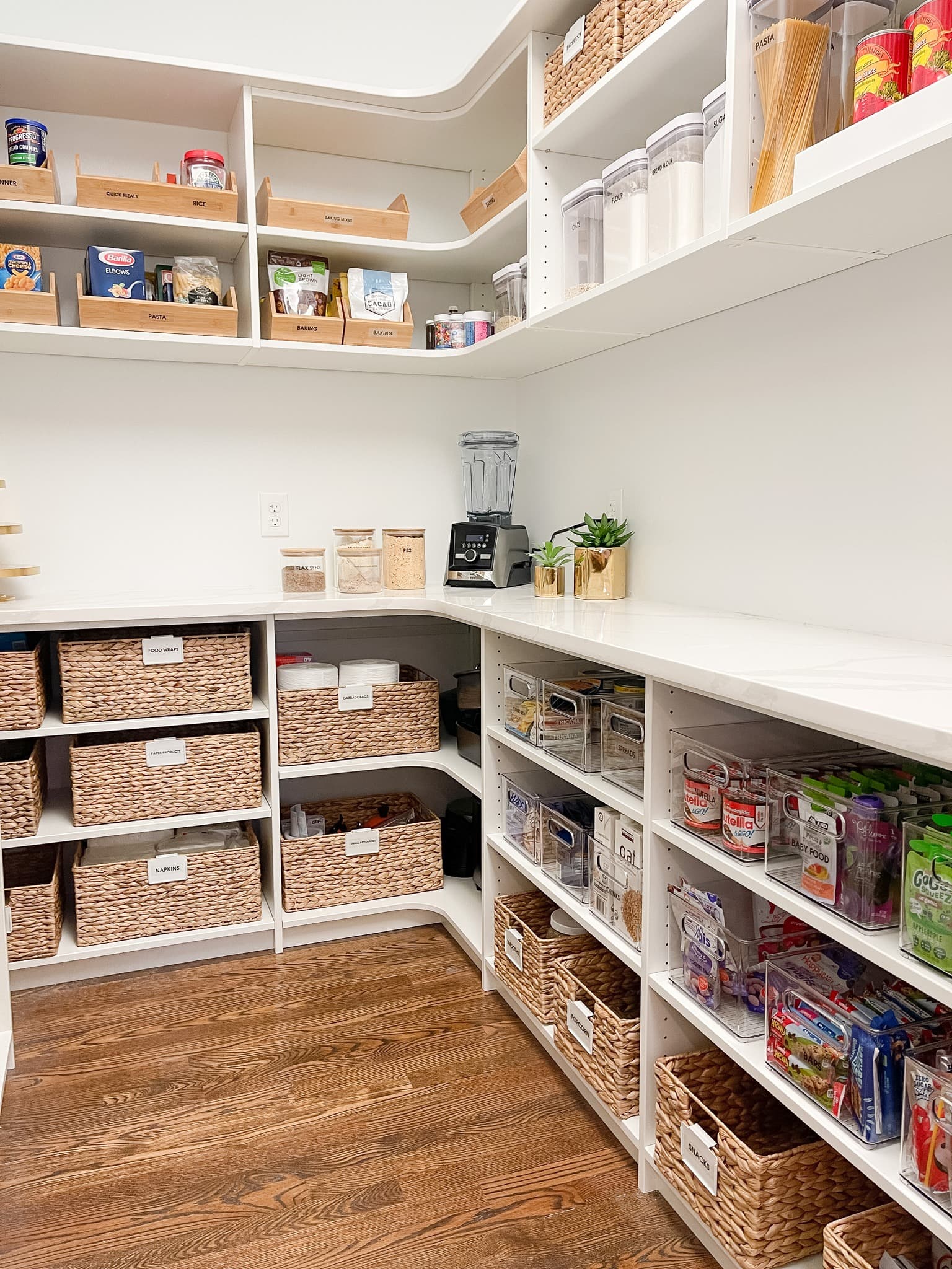 Organized walk-in pantry filled with storage containers and supplies